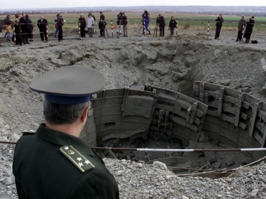 A Ukrainian army officer looks at a destroyed SS-24 missile silo near the town of Pervomaisk, Ukraine, October 30, 2001, photo by Gleb Garanich CVI/CLH//Reuters
