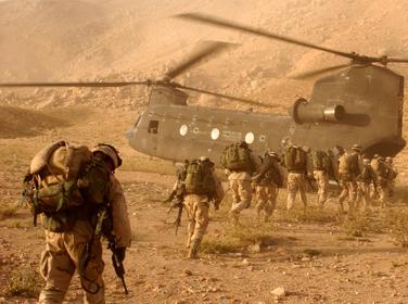 Soldiers quickly walk to the ramp of the CH-47 Chinook cargo helicopter that will return them to Kandahar Army Air Field.