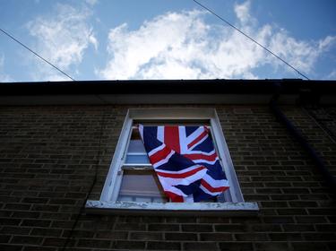 A British flag flutters in front of a window in London, Britain, June 24, 2016 after Britain voted to leave the European Union in the EU BREXIT referendum.