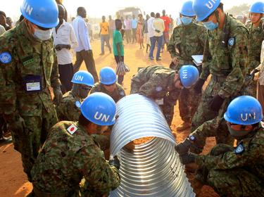 United Nations Mission in South Sudan peacekeepers from Japan assemble a drainage pipe at Tomping camp in Juba, January 7, 2014