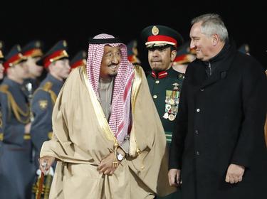 Saudi Arabia's King Salman (L) speaks with Russian Deputy Prime Minister Dmitry Rogozin (R) during a welcoming ceremony upon his arrival in Moscow, Russia, October 4, 2017