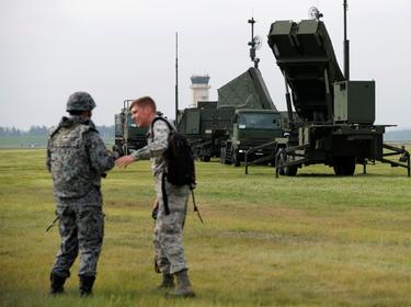 A Japan Self-Defense Forces soldier (L) talks with a U.S. Forces soldier during a drill to mobilise JSDF's PAC-3 missile unit in response to a recent missile launch by North Korea, at U.S. Air Force Yokota Air Base in Fussa on the outskirts of Tokyo, Japan, August 29, 2017