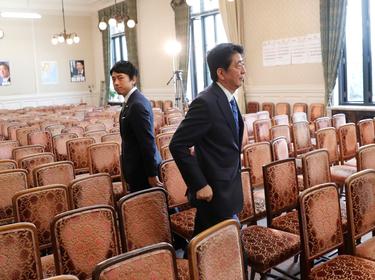 Japan's Prime Minister Shinzo Abe (right) and lawmaker Shinjiro Koizumi part ways at the Parliament in Tokyo, September 28, 2017