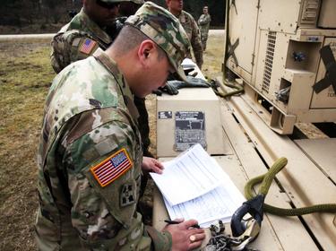 Sling load inspector checks the load plan paperwork prior to sling load operations with the 44th Expeditionary Signal Battalion March 22, 2016 at the Grafenwoehr Training Area, Germany