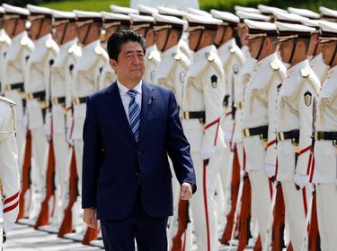 Japan's Prime Minister Shinzo Abe reviews the honor guard before a meeting with Japan Self-Defense Force's senior members at the Defense Ministry in Tokyo, Japan, September 11, 2017