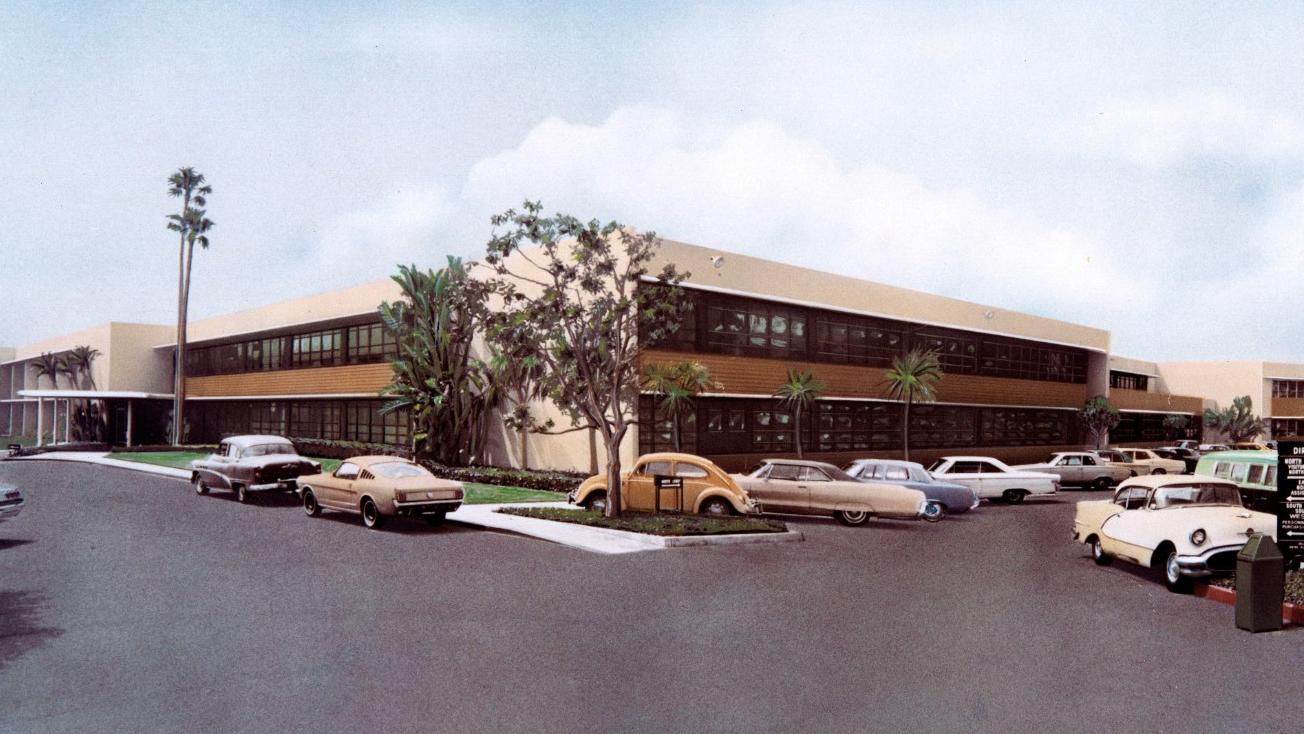 Hand-tinted photo of the RAND building on 1700 Main Street with parking lot, ca. 1960s