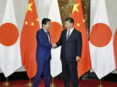 Japan's Prime Minister Shinzo Abe (L) shakes hands with China's President Xi Jinping during a meeting in Beijing, China, October 26, 2018