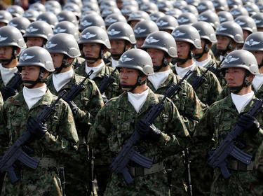 Members of Japan's Self-Defence Forces' airborne troops stand at attention during the annual SDF ceremony at Asaka Base, Japan, October 23, 2016, photo by Kim Kyung Hoon/Reuters