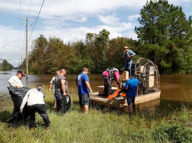 Members of the Cajun Navy transport loggers to clear power lines after Tropical Storm Florence caused massive flooding in Whiteville, North Carolina, September 17, 2018, photo by Randall Hill/Reuters