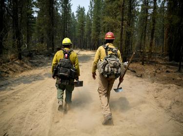 Firefighters mop up hotspots in the northwestern section of the Bootleg Fire in Oregon as it expands to over 210,000 acres, Klamath Falls, Oregon, July 14, 2021, photo by Mathieu Lewis-Rolland/Reuters