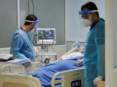 Medical staff members in an intensive care unit assist a patient suffering from COVID-19, Amman, Jordan March 23, 2021, photo by Muath Freij/Reuters