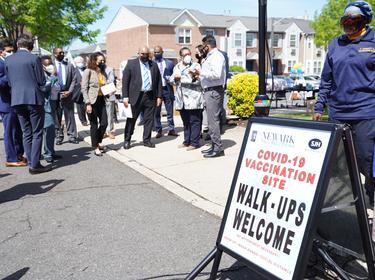 People standing outside a COVID-19 pop-up vaccination site in Newark, New Jersey, photo by U.S. Dept. of Housing and Urban Development (HUD) 