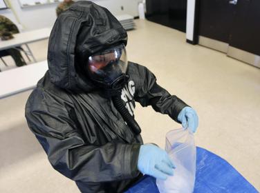 Lance Cpl. Nikolas Raven tests simulated biohazards during a mock training drill at Marine Corps Air Station Cherry Point, N.C., Feb. 19, 2016, photo by Cpl. Neysa Huertas Quinones/U.S. Marine Corps