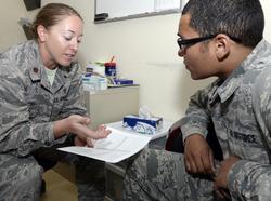 Maj. Jolyn, left, clinical health psychologist, and Staff Sgt. Ryan, mental health technician, demonstrate having a counseling session at an undisclosed location in Southwest Asia, March 16, 2015, photo by Tech. Sgt. Marie Brown/U.S. Air Force