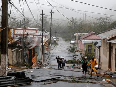 Rescue workers help people after the area was hit by Hurricane Maria in Guayama, Puerto Rico, September 20, 2017, photo by Carlos Garcia Rawlins/Reuters