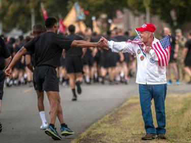 A veteran and a Soldier of I Corps exchange a passing greeting during the Corps Army birthday run at JBLM, Wash., June 14, 2019, photo by SPC Adeline Witherspoon, 16th Combat Aviation Brigade/U.S. Army
