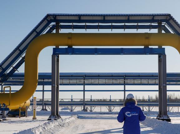 An employee walks past a part of Gazprom's Power Of Siberia gas pipeline at the Atamanskaya compressor station outside the far eastern town of Svobodny, in Amur region, Russia, November 29, 2019, photo by Maxim Shemetov/Reuters