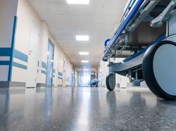 Medical bed on wheels in the hospital corridor, photo by beerkoff/Getty Images