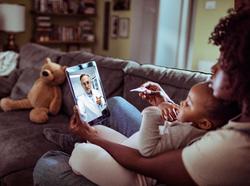 Close up of a mother and daughter consulting with their doctor over a video call on their digital tablet, photo by Geber86/Getty Images, Close up of a mother and daughter consulting with their doctor o