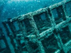 Numerous square concrete blocks are stacked on top of each other underwater to create an artificial reef, photo by Placebo365/Getty Images
