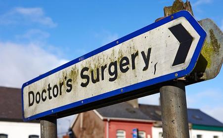 Sign for local doctor's surgery Dunmurry Belfast, UK, photo by Radharc Images/Alamy Stock Photo