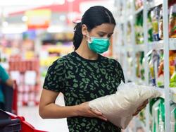 Female wearing a mask while shopping in the grocery store, photo by Space_Cat/Adobe Stock