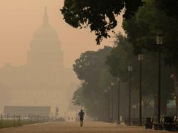 A person runs on the National Mall as the U.S. Capitol is shrouded in haze and smoke caused by wildfires in Canada, in Washington, D.C., June 8, 2023, photo by Amanda Andrade-Rhoades/Reuters