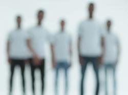 Blurry image of a group of young black men in white t-shirts, photo by ASDF/Getty Images