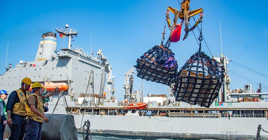 Sailors aboard the USS <em>Winston S. Churchill</em> send pallets to the USNS <em>Leroy Grumman</em> in the Arabian Sea, January 19, 2021, photo by Petty Officer 3rd Class Louis Staats/U.S. Navy