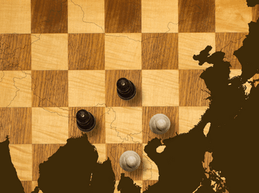 Old wooden chess board with map, photo by Chess board: ChrisAt/Getty Images/iStockphoto. Map: pc/Getty Images Chess pieces: TheUltimatePhotographer/iStockphoto